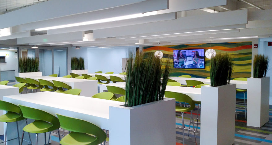 Solicore plastic laminate tables with integrated planters, and custom plastic laminate floating ceiling beams.