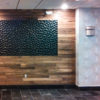 Walnut slat wall with inset painted and textured panel.