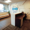 Custom plywood/plastic laminate wall panels and reception desk with matching transaction top surround.